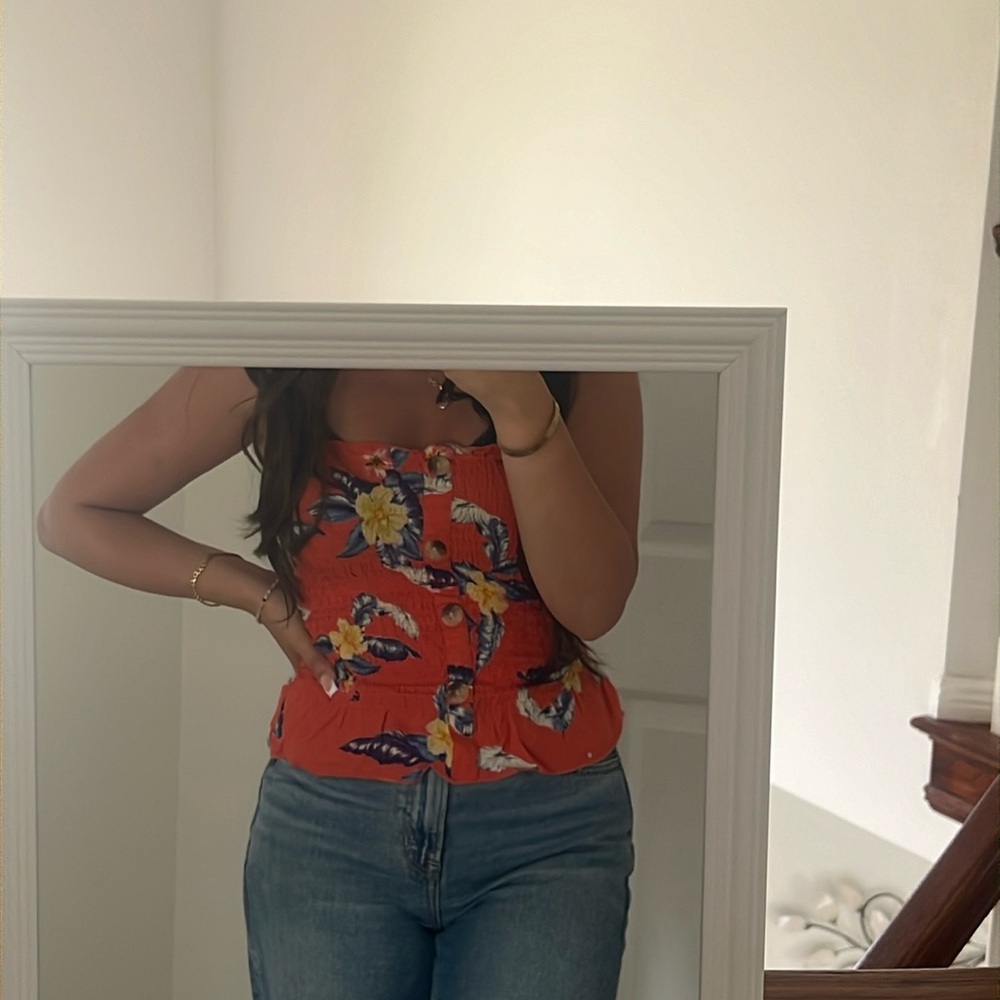 Very cute orange tube top with flowers.
